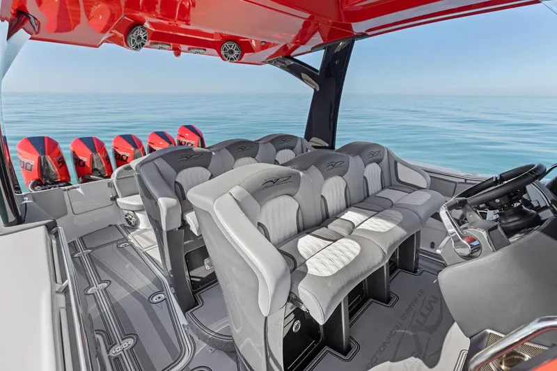 Slide: The Image of 2024 MTI V42 boat interior with luxury seating and multiple outboard engines. - 77