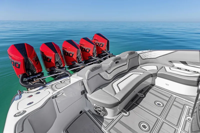 Slide: The Image of 2024 MTI V42 boat with five red outboard engines on calm water. - 79