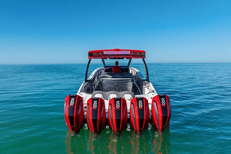 Slide: The Image of 2024 MTI V42 boat with five powerful outboard engines on calm blue water. - 8