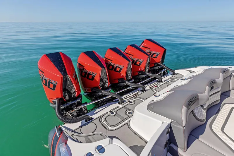 Slide: The Image of 2024 MTI V42 boat with four powerful red outboard engines on calm water. - 84