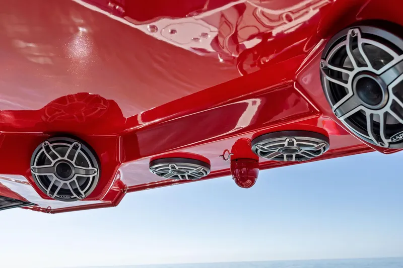 Slide: The Image of Red MTI V42 boat with sleek speakers, 2024 model, against a clear sky. - 88