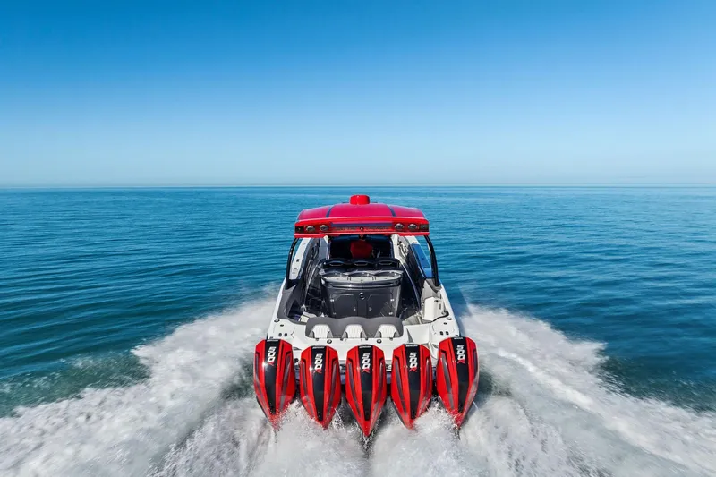 Slide: The Image of 2024 MTI V42 speedboat with five powerful outboard engines cruising on open water. - 9