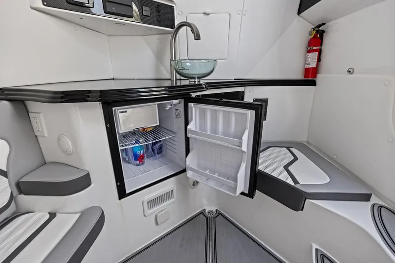Slide: The Image of 2024 MTI V42 interior with open mini-fridge, modern sink, and fire extinguisher. - 94