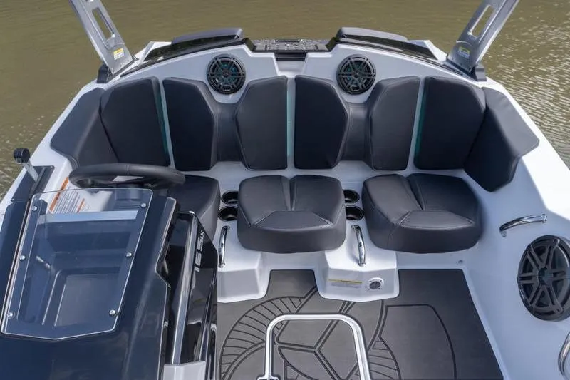 Slide: The Image of 2026 Scarab 165 LX boat interior with black seating and modern design. - 11