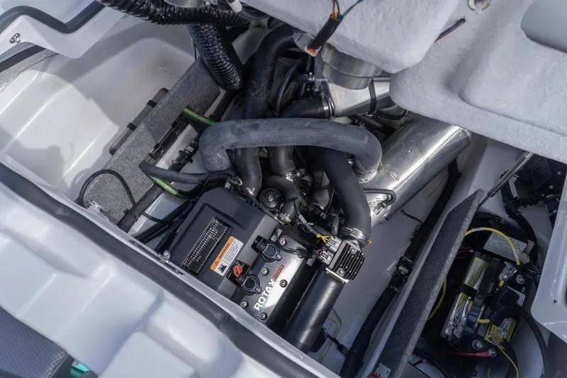 Slide: The Image of Engine compartment of 2026 Scarab 165 LX boat, showcasing mechanical components and wiring. - 13