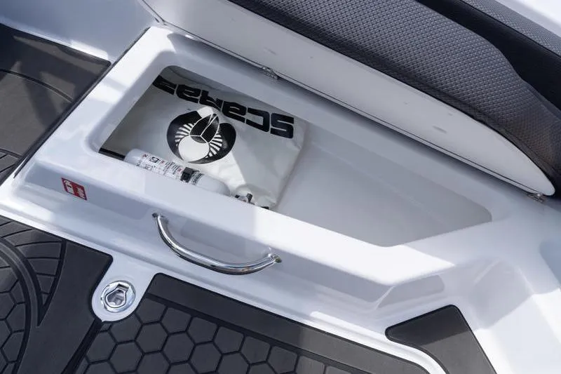 Slide: The Image of Storage compartment in 2026 Scarab 165 LX boat with branded items and accessories. - 8
