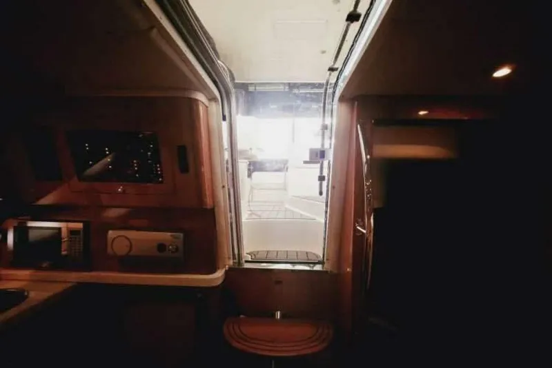 Slide: The Image of Interior view of 2007 Regal Commodore 4460 yacht, showcasing cabin and deck access. - 15