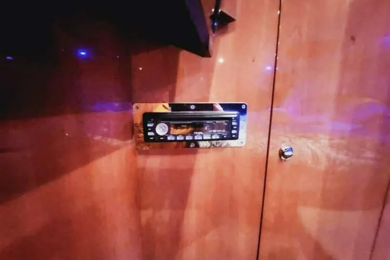 Slide: The Image of 2007 Regal Commodore 4460 interior with built-in stereo system on wooden panel. - 16