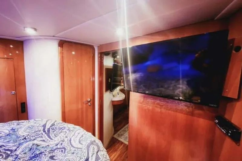 Slide: The Image of Luxurious interior of 2007 Regal Commodore 4460 yacht with TV and wooden finish. - 18