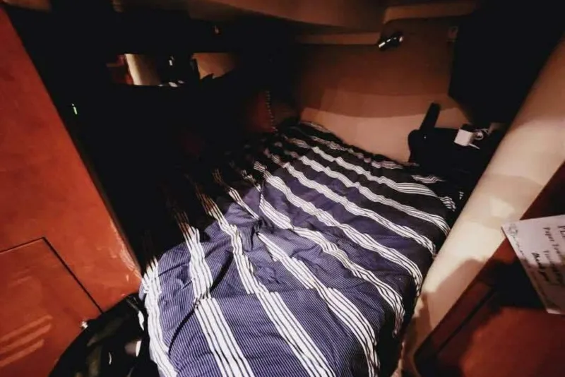 Slide: The Image of Cozy cabin interior of 2007 Regal Commodore 4460 with striped bedding. - 20