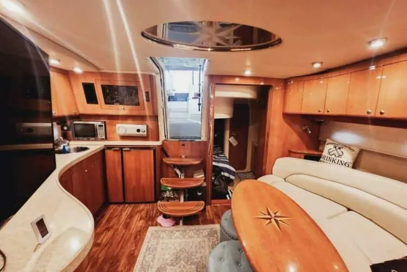 Slide: The Image of Luxurious interior of 2007 Regal Commodore 4460 yacht with modern kitchen and seating area. - 21