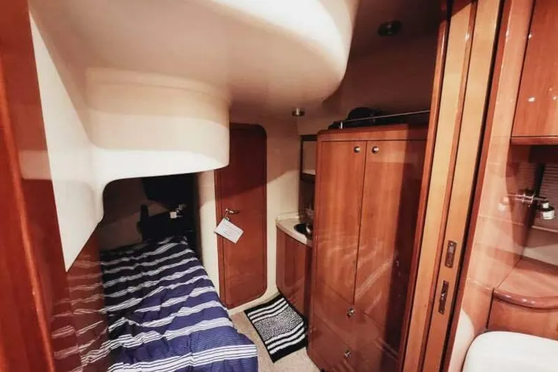 Slide: The Image of 2007 Regal Commodore 4460 yacht interior with cozy cabin and wooden cabinetry. - 22