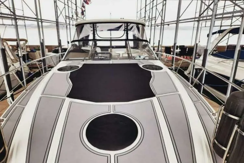 Slide: The Image of 2007 Regal Commodore 4460 yacht docked in a marina, showcasing sleek design and spacious deck. - 7