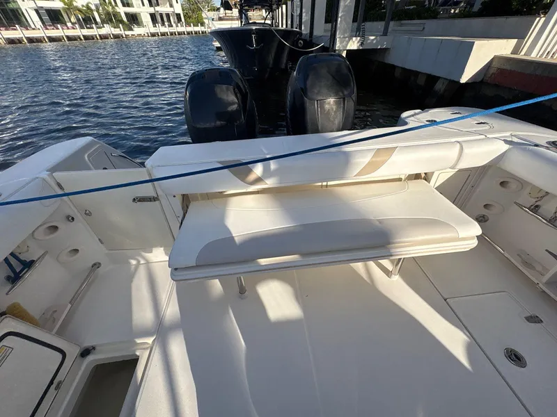 Slide: The Image of 2007 Boston Whaler 305 Conquest boat interior with seating and twin outboard motors. - 12