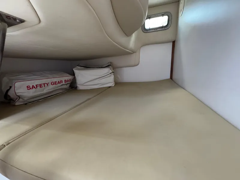 Slide: The Image of 2006 Boston Whaler 305 Conquest cabin interior with safety gear bag. - 21