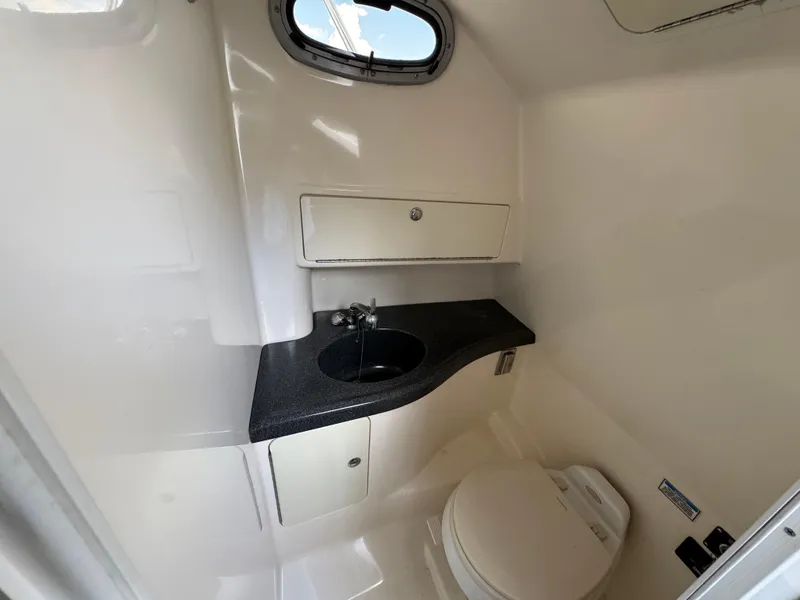 Slide: The Image of 2006 Boston Whaler 305 Conquest boat bathroom with sink and toilet. - 22