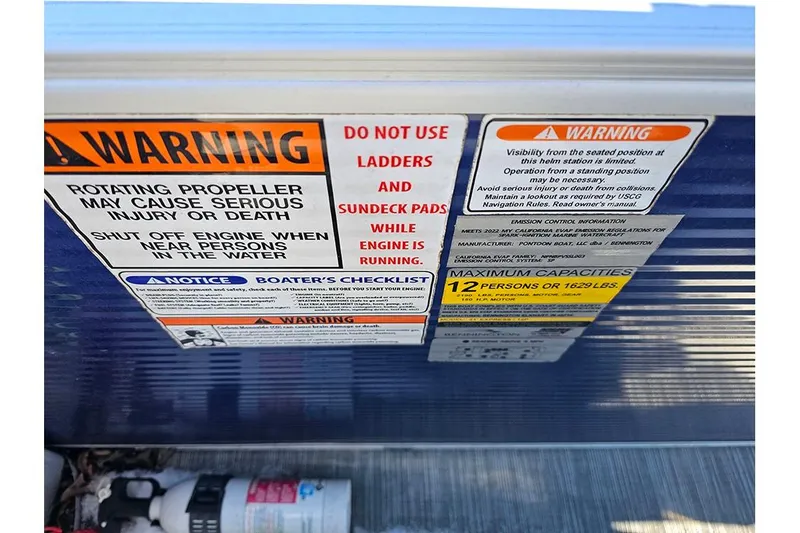 Slide: The Image of Warning labels on a 2022 Bennington 22SF boat, highlighting safety precautions and capacity limits. - 10