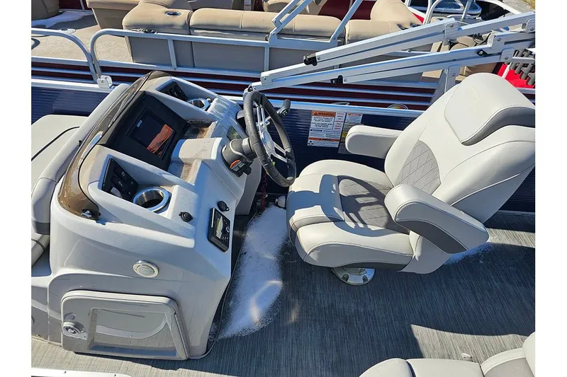 Slide: The Image of Captain's seat and helm of 2022 Bennington 22SF pontoon boat, featuring modern controls. - 9