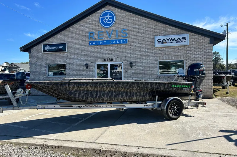 Slide: The Image of 2025 Havoc 1860 Dbst boat on trailer outside Revis Yacht Sales building. - 1