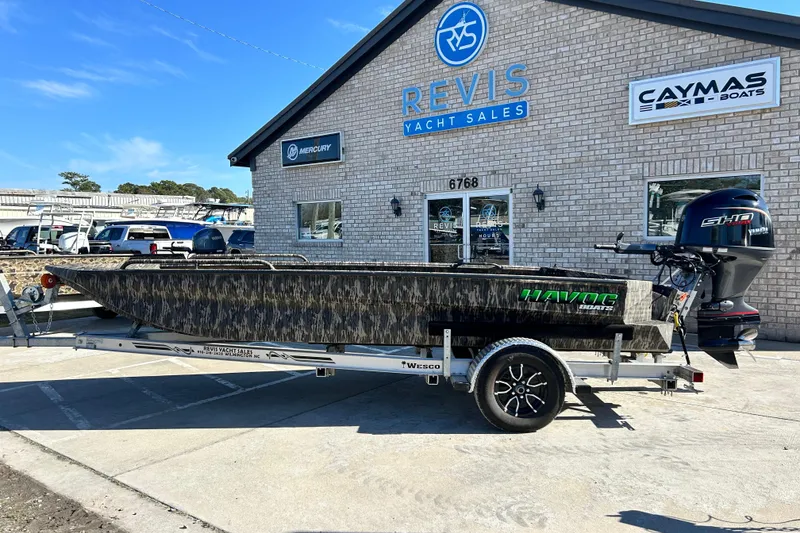 Slide: The Image of 2025 Havoc 1860 Dbst boat on trailer at Revis Yacht Sales dealership. - 2