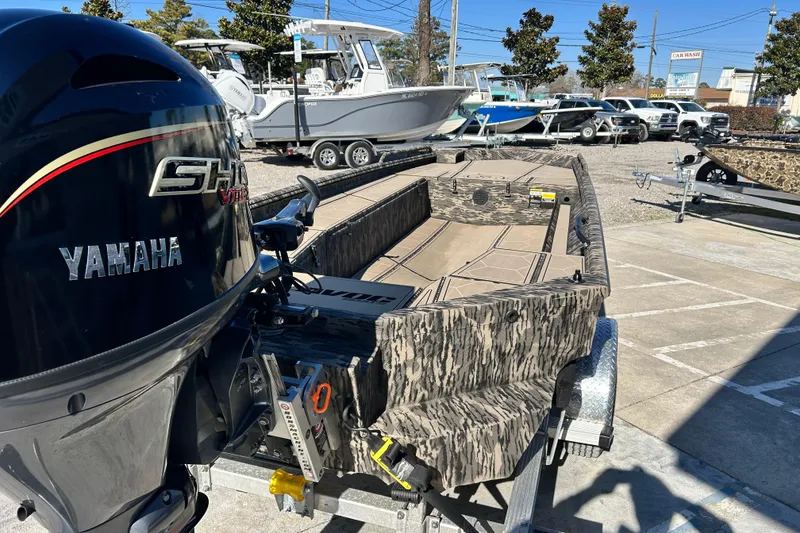 Slide: The Image of 2025 Havoc 1860 Dbst boat with Yamaha engine, camo design, parked on trailer. - 5