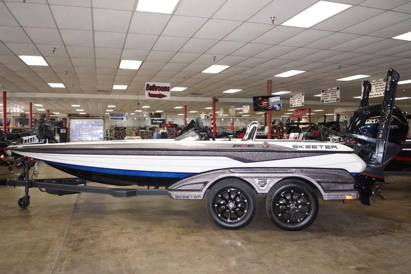 The Image of 2026 Skeeter FXR20 FLEX boat displayed indoors on a trailer. - 1