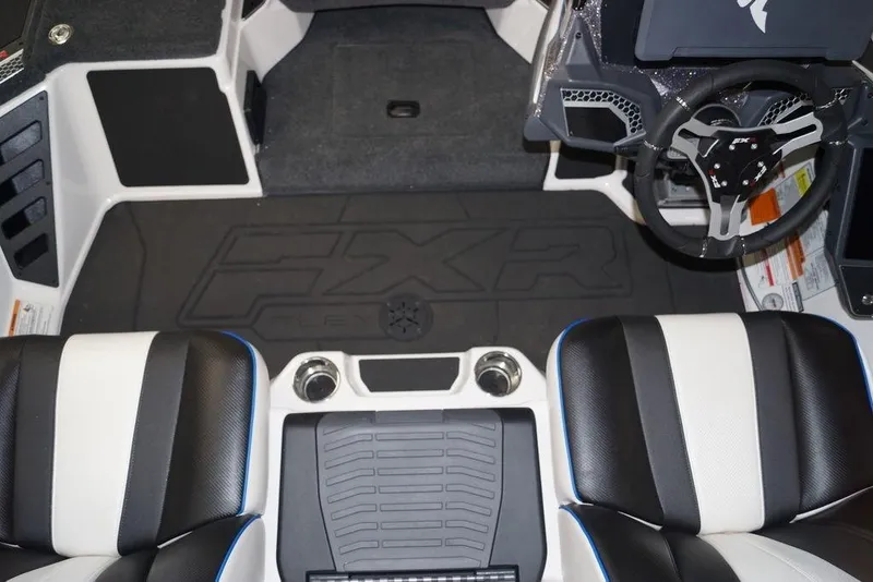 Slide: The Image of 2026 Skeeter FXR20 FLEX boat interior with black and white seats and steering wheel. - 10