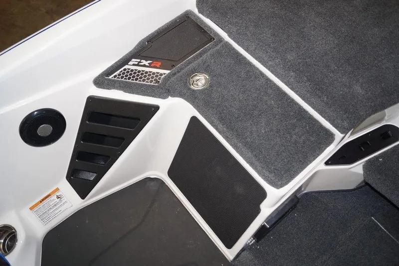 Slide: The Image of 2026 Skeeter FXR20 FLEX boat interior with carpeted flooring and storage compartments. - 12