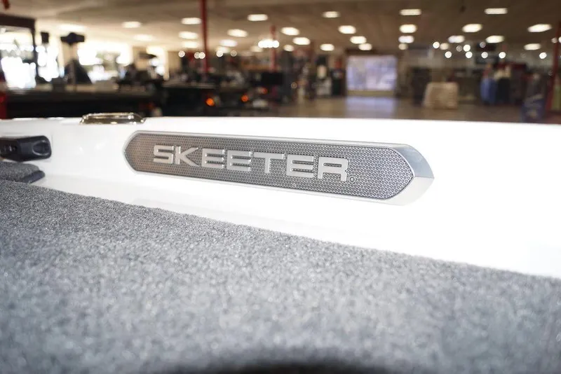 Slide: The Image of 2026 Skeeter FXR20 FLEX boat interior with logo detail in showroom. - 18