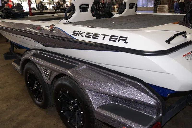 Slide: The Image of 2026 Skeeter FXR20 FLEX boat with sleek design and dual-axle trailer. - 2