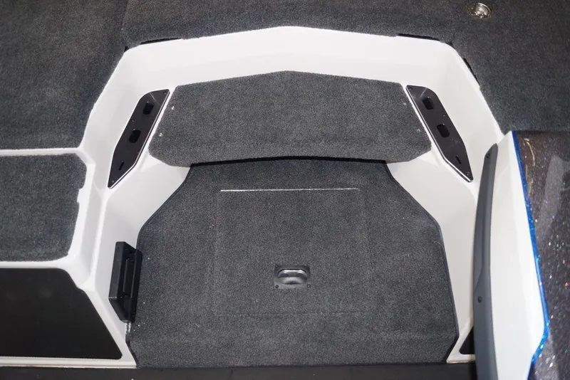 Slide: The Image of 2026 Skeeter FXR20 FLEX boat interior with gray carpeted flooring and storage compartments. - 20