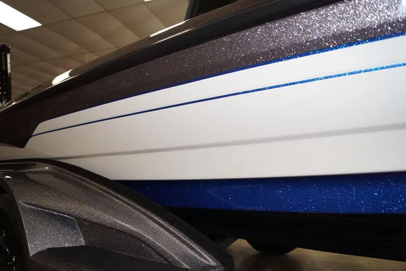 Slide: The Image of 2026 Skeeter FXR20 FLEX boat with sleek, glittering blue and white design. - 27