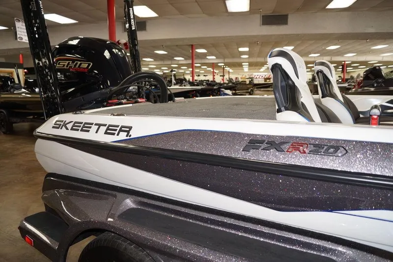 Slide: The Image of 2026 Skeeter FXR20 FLEX boat in showroom, featuring sleek design and modern seating. - 28