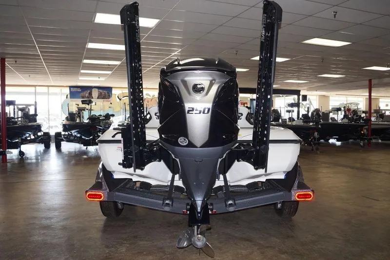 Slide: The Image of 2026 Skeeter FXR20 FLEX boat in showroom, rear view with powerful engine. - 3