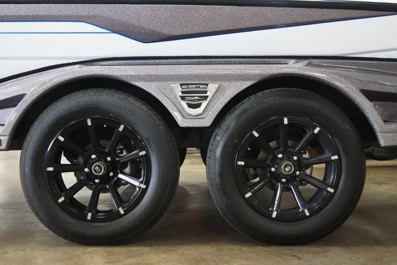 Slide: The Image of 2026 Skeeter FXR20 FLEX trailer with black alloy wheels and sleek design. - 7