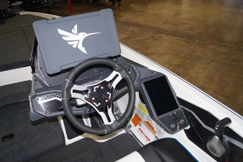 Slide: The Image of 2026 Skeeter FXR20 FLEX boat dashboard with steering wheel and control panel. - 8