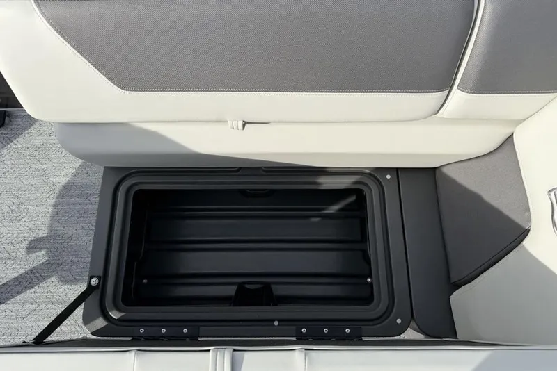 Slide: The Image of Open storage compartment in 2026 Sun Tracker Fishin' Barge 22 DLX boat seat. - 10
