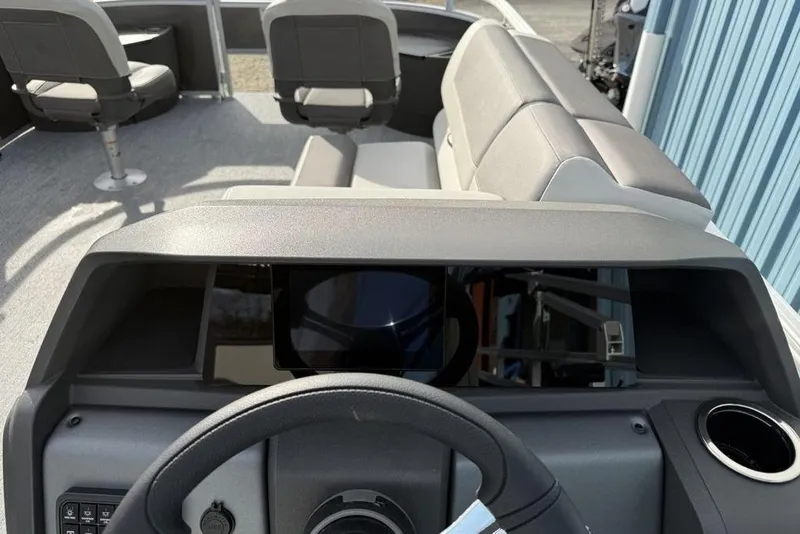 Slide: The Image of Interior view of 2026 Sun Tracker Fishin' Barge 22 DLX pontoon boat dashboard and seating. - 11
