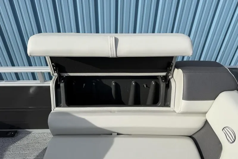 Slide: The Image of 2026 Sun Tracker Fishin' Barge 22 DLX seat storage compartment open, showcasing interior space. - 12