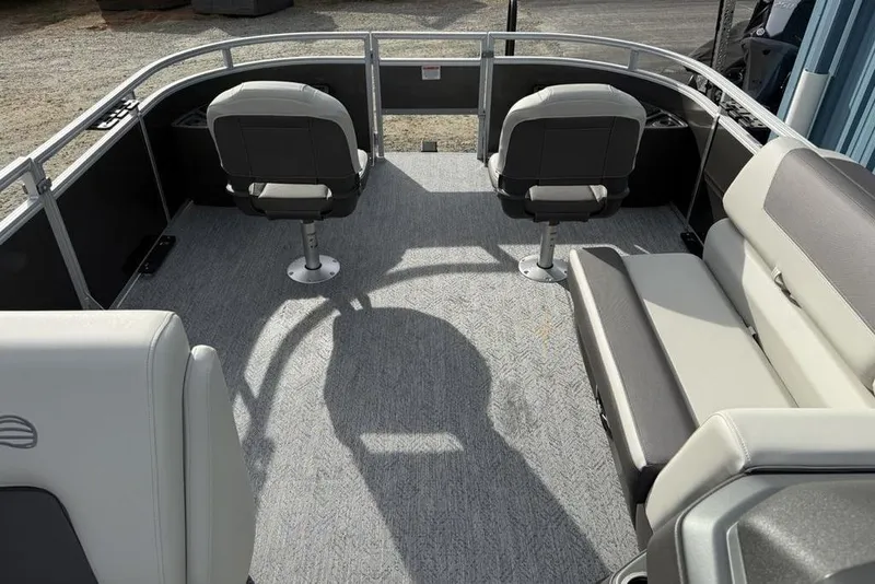 Slide: The Image of 2026 Sun Tracker Fishin' Barge 22 DLX interior with seating and open deck space. - 2