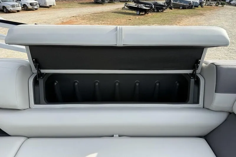Slide: The Image of 2026 Sun Tracker Fishin' Barge 22 DLX storage compartment with open seat lid. - 23