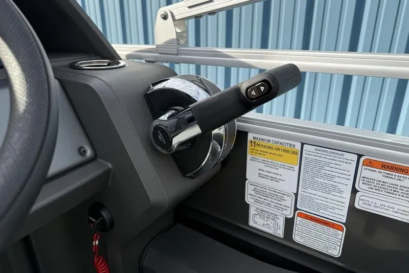 Slide: The Image of Control panel of 2026 Sun Tracker Fishin' Barge 22 DLX with capacity warnings. - 24