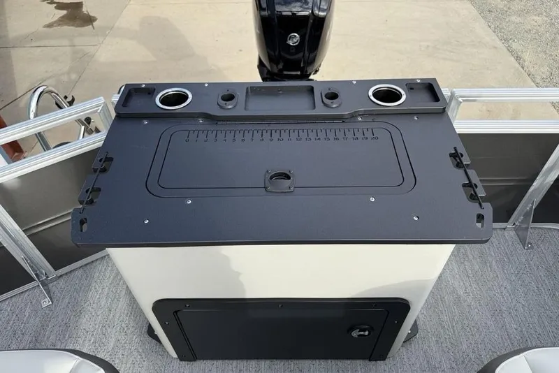 Slide: The Image of 2026 Sun Tracker Fishin' Barge 22 DLX fishing station with cup holders and storage. - 25