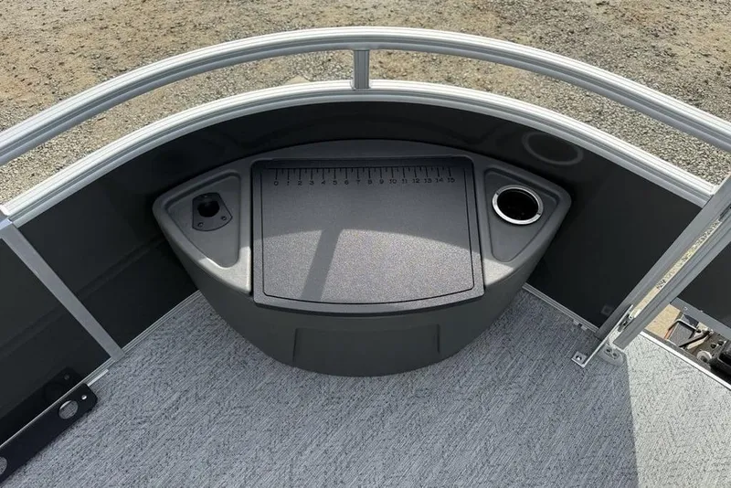 Slide: The Image of 2026 Sun Tracker Fishin' Barge 22 DLX deck with storage and cup holder. - 34