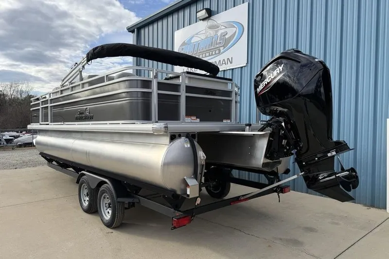 Slide: The Image of 2026 Sun Tracker Fishin' Barge 22 DLX pontoon boat with Mercury outboard motor. - 4