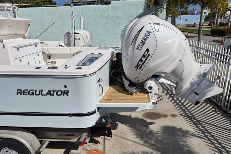 Slide: The Image of 2026 Regulator 31 boat with Yamaha XTO outboard engine, parked on a trailer. - 18