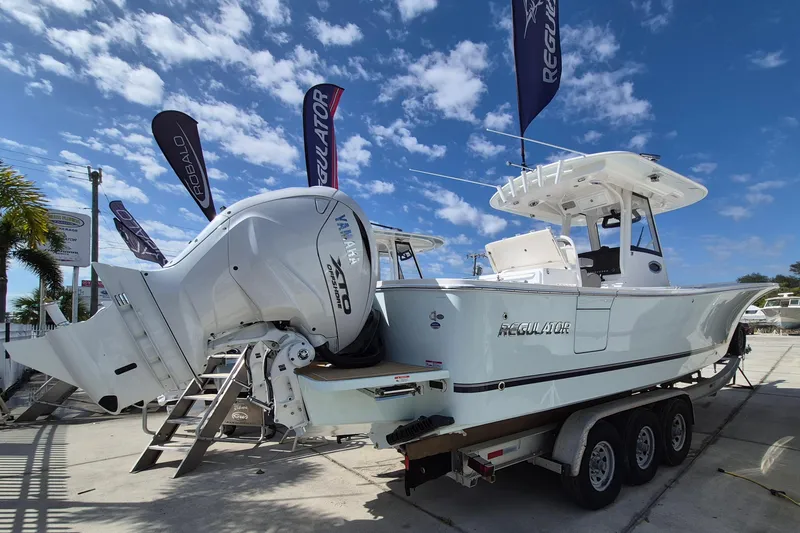 Slide: The Image of 2026 Regulator 31 boat with Yamaha engines on a trailer, under a clear blue sky. - 19
