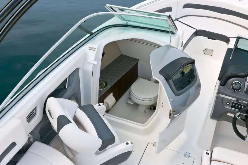 Slide: The Image of Manufacturer Provided Image: 2016 Chaparral 246 SSi boat interior with a compact bathroom and seating area. - 10