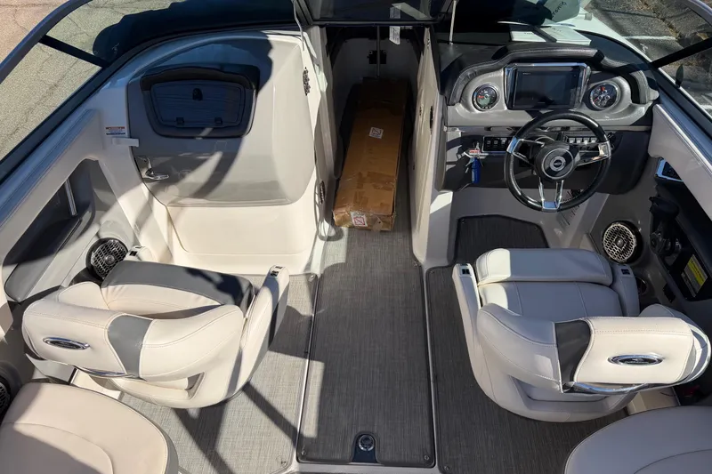 Slide: The Image of 2016 Chaparral 246 SSi boat interior with steering wheel and seating arrangement. - 3