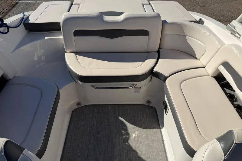 Slide: The Image of 2016 Chaparral 246 SSi boat interior with cushioned seating and sleek design. - 4